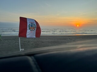Bandera Peruana flameando frente al mar
