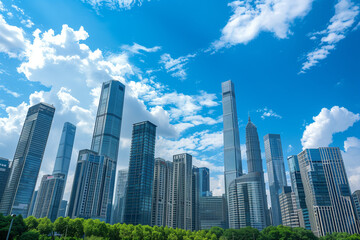 Fototapeta premium Skyscrapers Reaching into a Bright Blue Sky with White Clouds on a Sunny Day