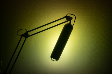 The table lamp shines into the wall