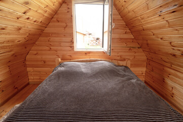 Empty bedroom in wooden house 