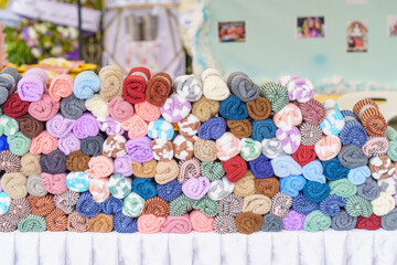 Many colorful rolls of cloth on the table