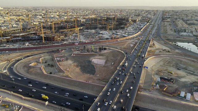 Drone view of busy complex road junction and mega construction on background in Saudi Arabia Riyadh