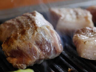 Korean bbq Grilled Prok Belly Samgyupsal on a grill, Korean favorite food 삼겹살