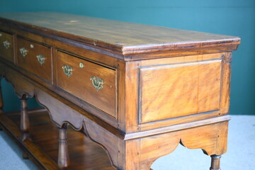 Antique oak sideboard on plain background, close up