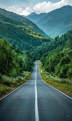 Fototapeta premium A long road with a mountain range in the background