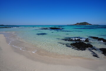 shoaling clear beach and far island