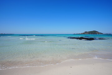 shoaling clear beach and far island