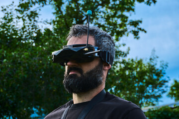 FPV drone man pilot portrait outdoor on training polygon. Guy copter vr operator engineer testing...
