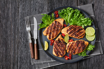 grilled chicken breasts wrapped in bacon on plate