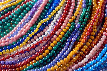 A cheerful array of colorful friendship beads strung together to form a necklace, symbolizing unity.