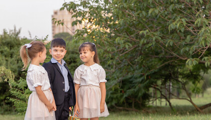 boy and girls in park with blackboard and chalk inscription back to school or abc.child playing in teacher and students.sitting on grass children.going to lessons preschoolers,walking on road.autumn