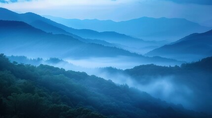 Fototapeta premium A series of blue misty mountains with trees and fog in the foreground