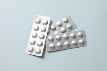 Pills in blisters on a colored background