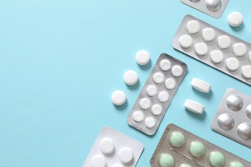 Pills in blisters on a colored background