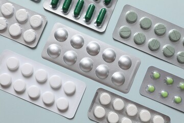 Pills in blisters on a colored background
