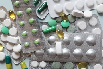 Pills in blisters on a colored background