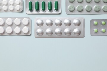 Pills in blisters on a colored background