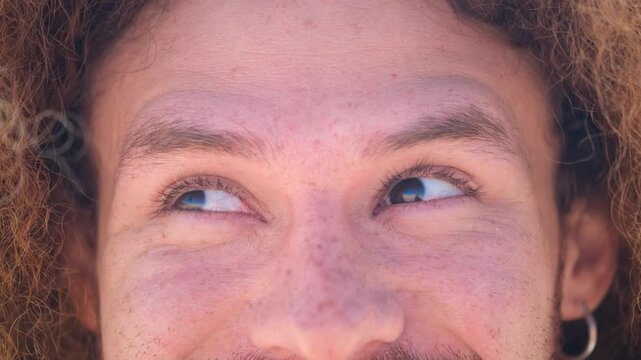 Close up of freckled skin man eyes raising his eyebrows and moving his eyes playfully