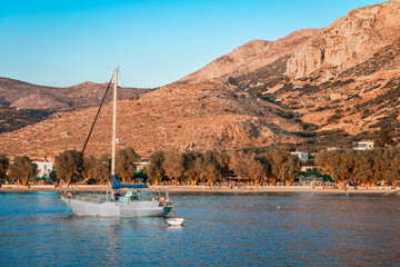 The waterfront of Aegiali in the sunset. Aegiali is a seaside village and a popular tourist...