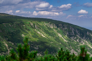 Mountain landscape, mountains in summer. view of the green mountain slopes, rocks on a beautiful summer day. mountain trail leading to the peak. top of the mountain