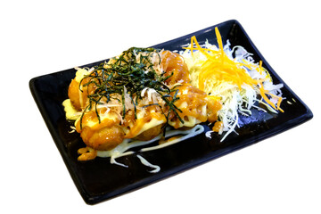 Takoyaki on a black plate on a white background.isolate