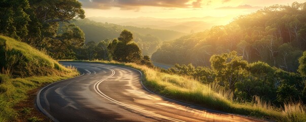 Fototapeta premium Winding road through lush green landscape at sunrise, with a warm and serene atmosphere, perfect for travel and nature themes.