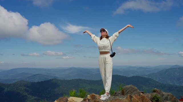 Woman Embraces Freedom on Mountaintop