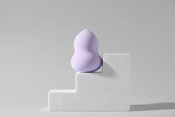 Stylish presentation of makeup sponge on light grey background