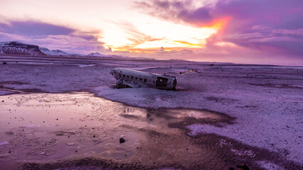 Aerial drone view at sunrise on crashed plane on frozen Solheimasandur beach in winter, Iceland