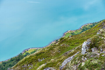 Farms by the coastline of the Lustrafjorden Fjord, Norway.