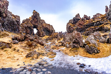 Frozen rock formations ice and snow on Djupalonssandur beach on Snaefellsnes peninsula in winter Iceland