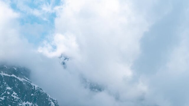 4K Timelapse shot of dark stormy clouds covering the snowy Himalayan mountain peaks as seen from Khangsar village in Lahaul Valley, Himachal Pradesh, India. Clouds above the snowy Himalayas.