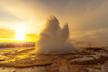 Beautiful eruption of the Strokkur Geyser at sunrise. Iceland's frozen winter is very cold