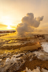 Strokkur Geyser eruption at sunrise. Iceland's frozen winter is very cold