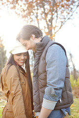 Fototapeta premium Happy, hugging and couple in nature for winter vacation, getaway or holiday together for anniversary. Smile, love and young man and woman embracing with care at romance date on weekend trip in Russia
