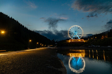 Night landscape, Ferris wheel with beautiful illumination at night. Attraction in Bukovel.