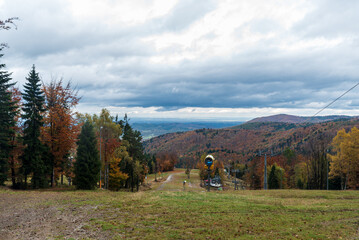 View from upper station of Czarny gron chairlift and ski slope on Czarny Gron ski resort in Beskid...