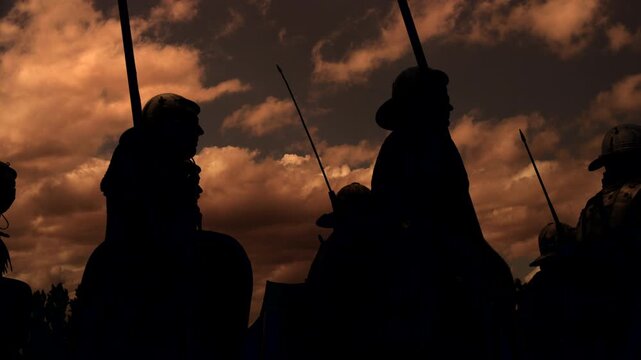 Silhouetted knights on horseback in a sunset sky embody medieval nobility and warrior spirit