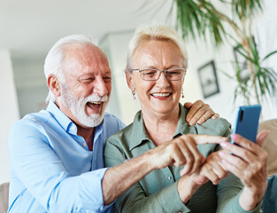 woman man senior retirement couple mobile phone phone home communication elderly adult happy smiling old mobile family husband mature wife