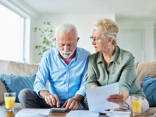 woman man senior bill finance retirement couple home document calculator paper wife  budget elderly...
