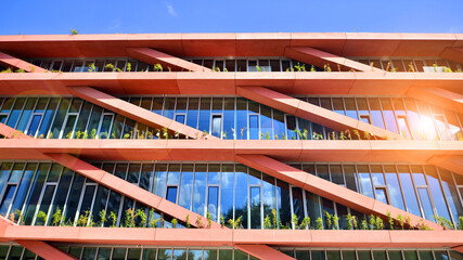 Modern office building with glass facade on a clear sky background. Transparent glass wall of office building. © Grand Warszawski