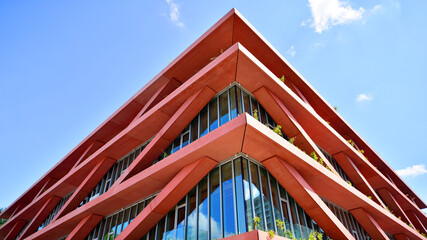 Modern office building with glass facade on a clear sky background. Transparent glass wall of...