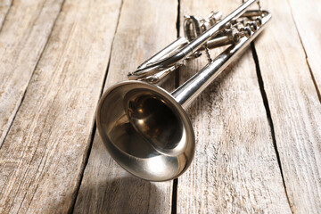 Obraz premium One trumpet on wooden table, closeup. Musical instrument