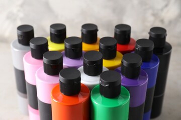 Acrylic paints of different colors on table, closeup