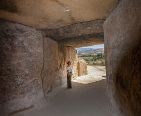 Caucasian mature woman visiting the dolmen of Antequera, Malaga, Spain.