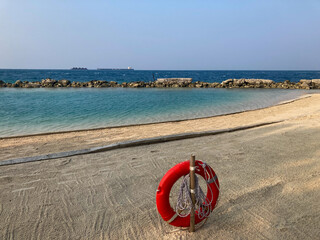 A lifebuoy is hanging at the beach in Pulau Payung.