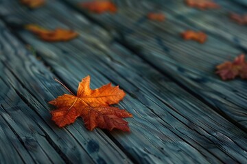 Obraz premium A close-up shot of a single leaf on a wooden surface, perfect for nature-inspired designs and projects