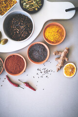 Bowl, powder and board in white background for spices, curry and sensory appeal for creativity with culinary. Studio, condiment and seasoning for cooking with ginger, aroma and ingredients collection