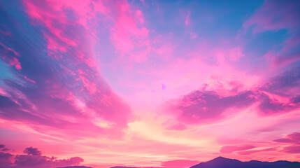 Stunning vibrant sunset with pink and purple clouds over a mountainous landscape, colorful sky