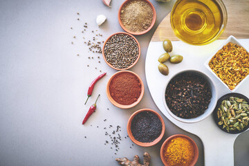 Bowl, chilli and board in gray background for spices, powder and sensory appeal for creativity with culinary. Studio, condiment and ingredients for cooking with clove, aroma and seasoning by space
